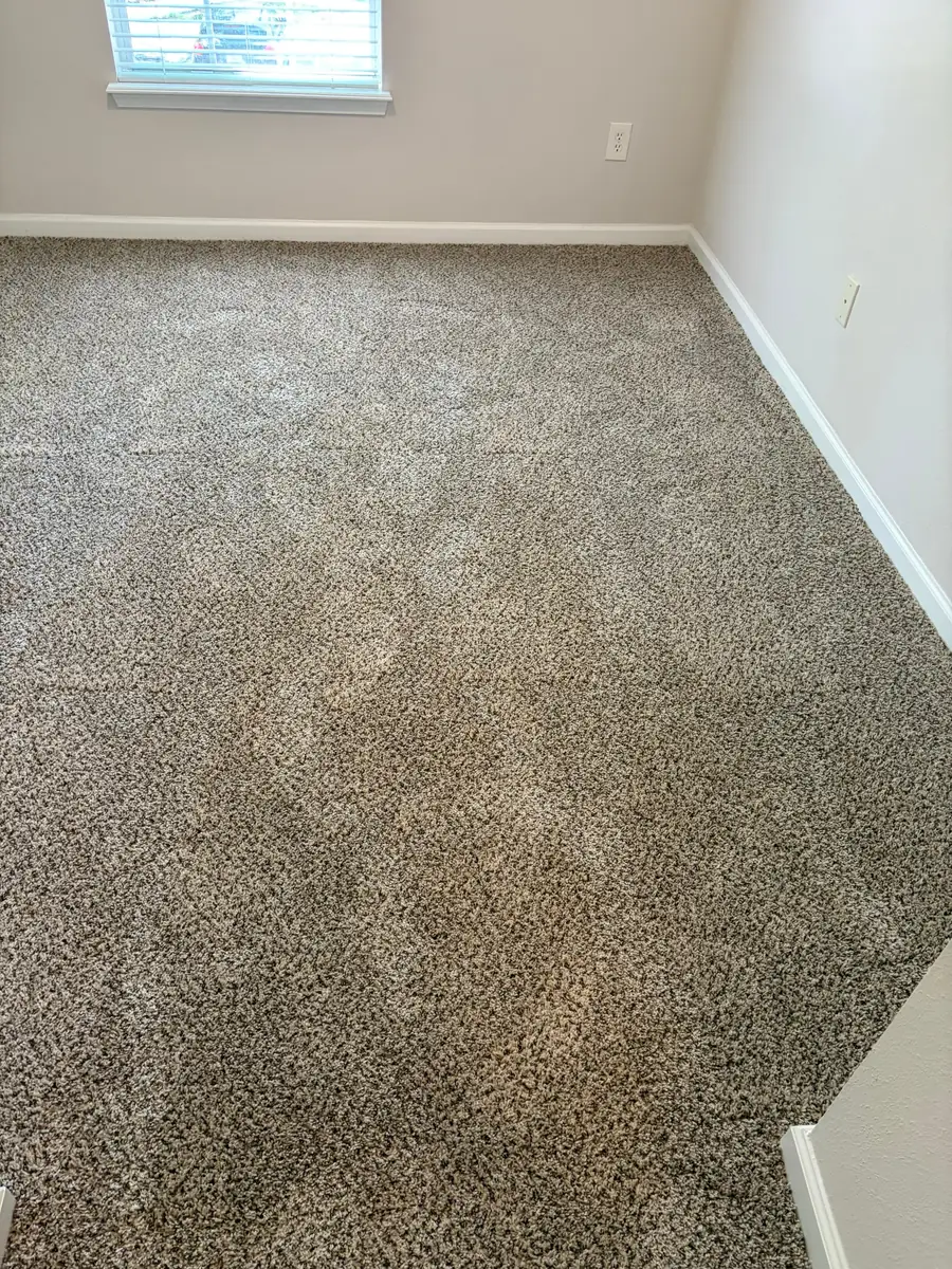 Textured beige carpet running wall to wall in a living room