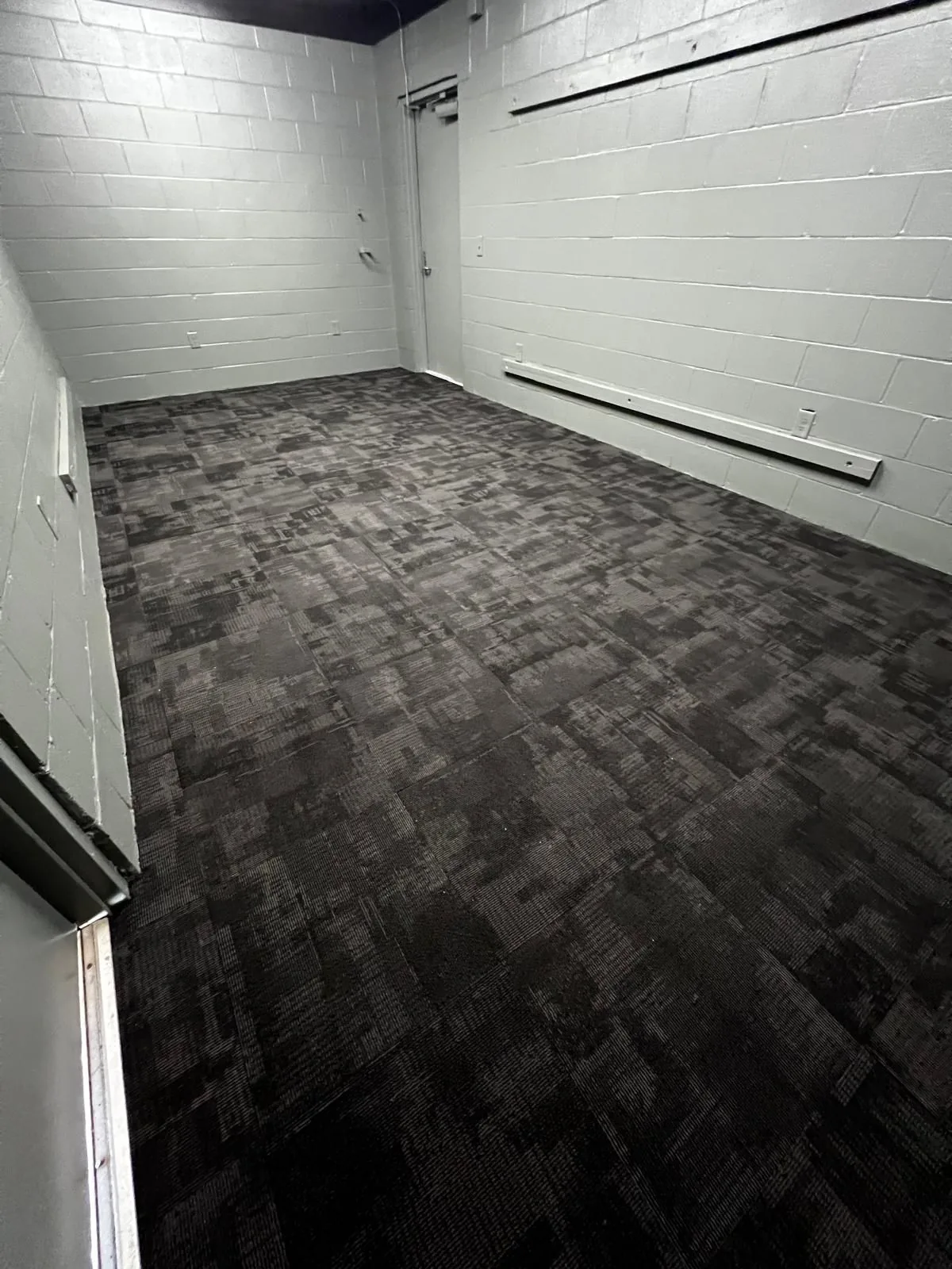 Carpet tile in an office suite with block walls