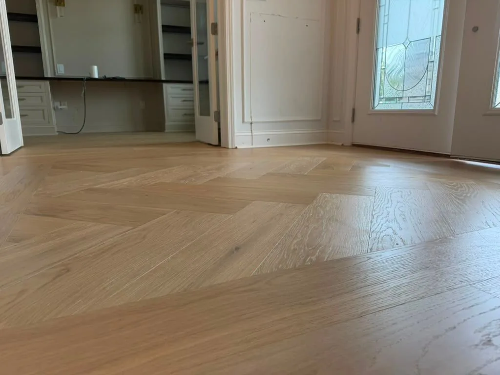 Herringbone hardwood floor running through a wide open room