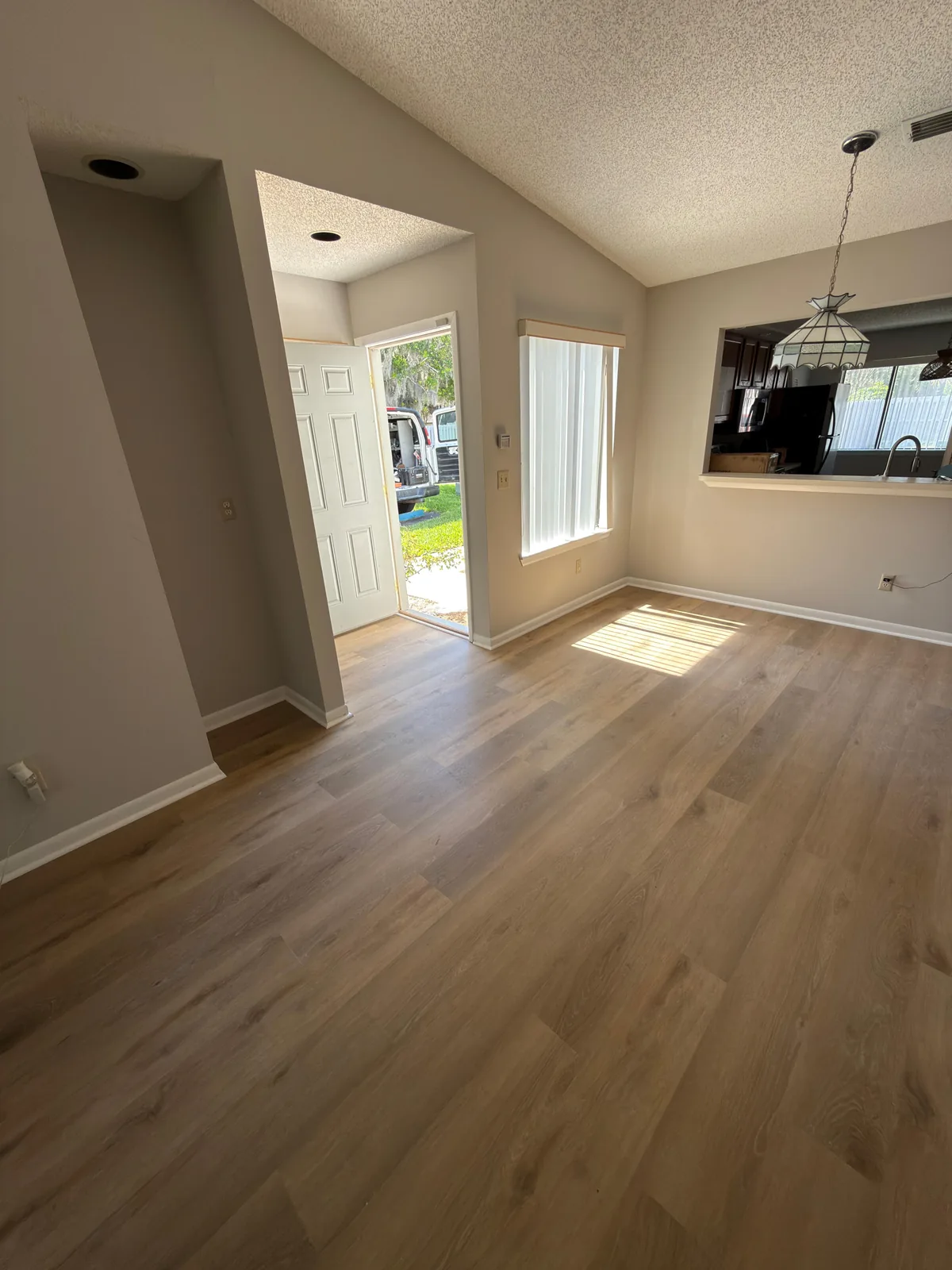 Luxury vinyl plank flooring across an open living and dining area