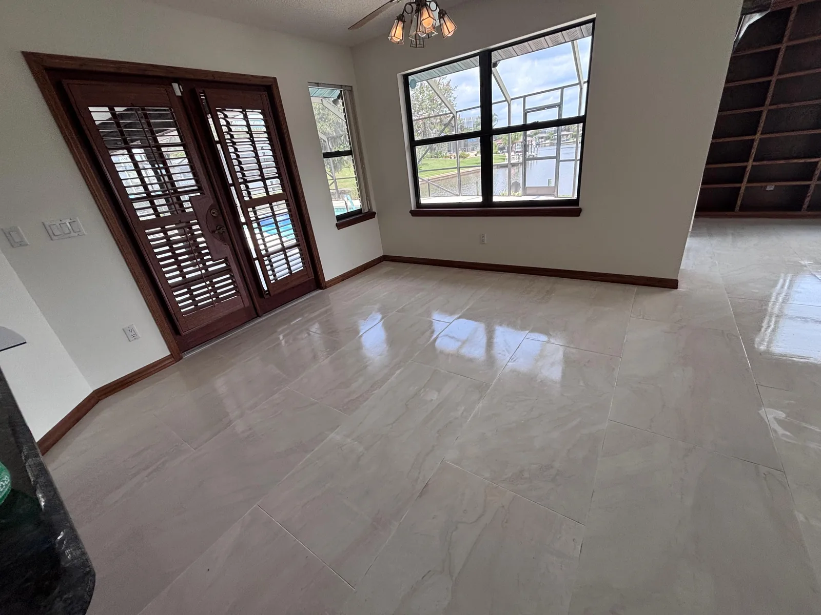 Porcelain tile floor in a room opening onto french doors