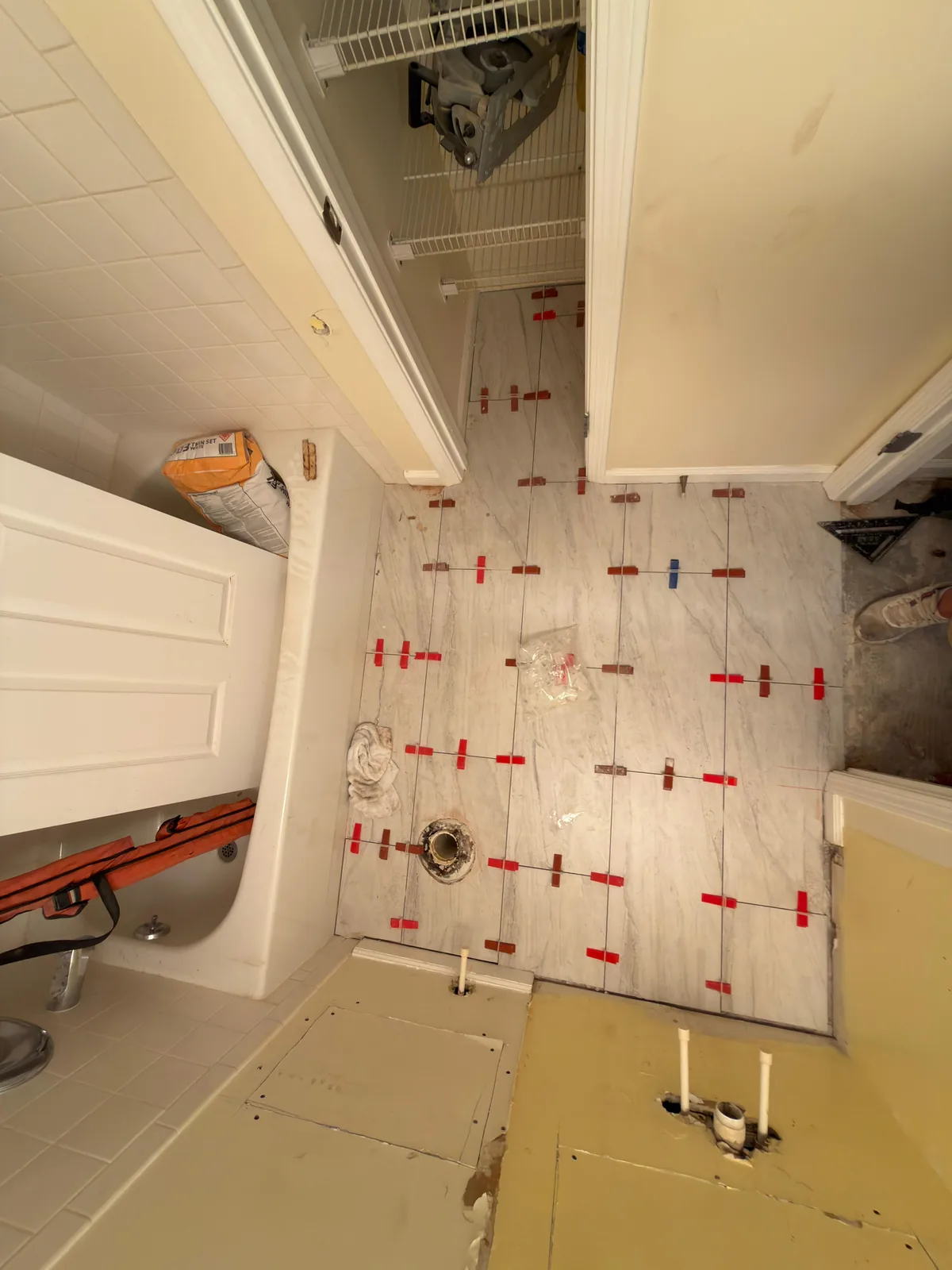 Tile being set with leveling clips during installation